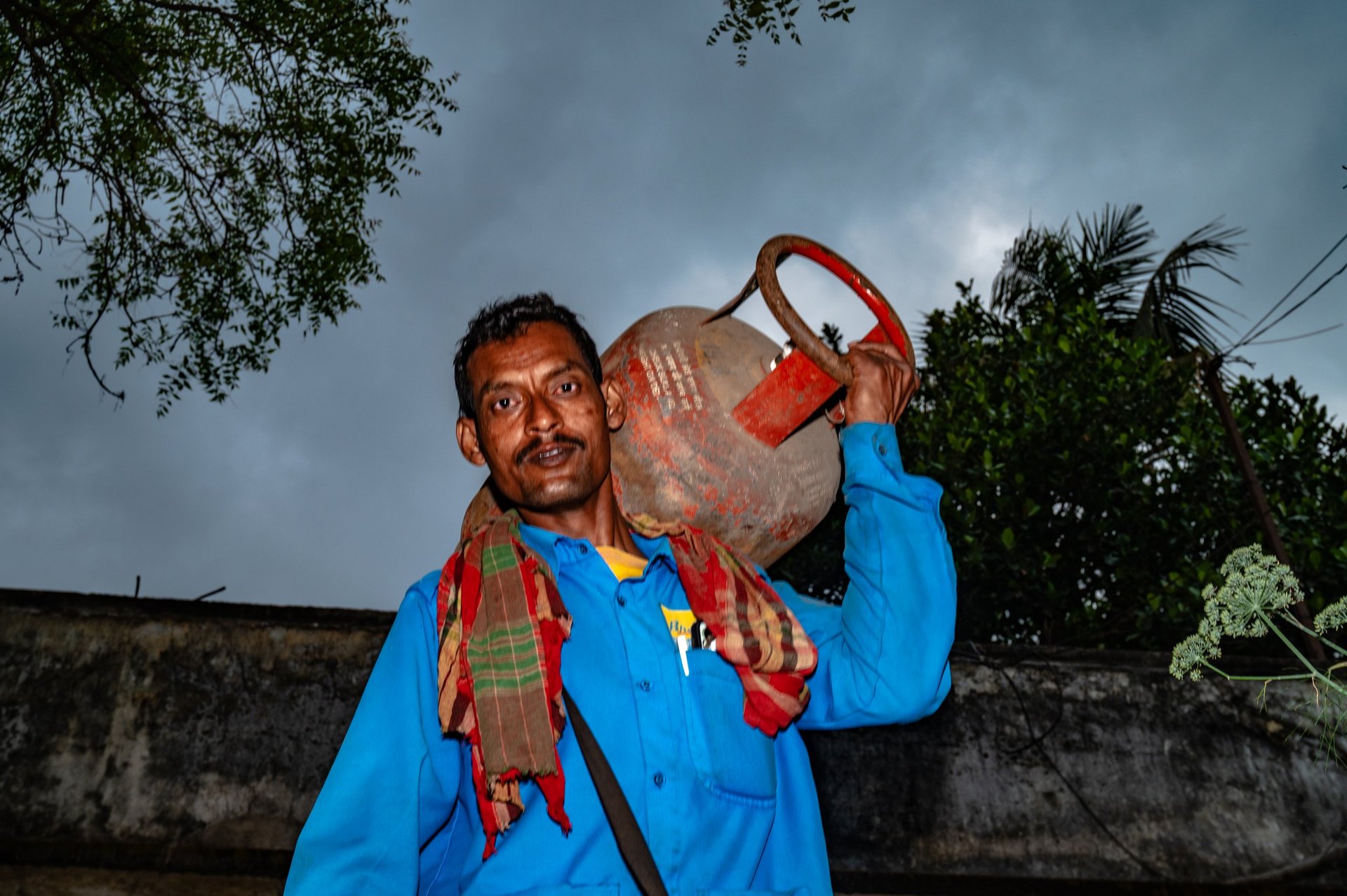 Person carrying LPG gas cylinder checking weight